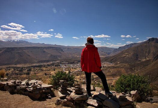 Rear view of senior woman standing above the valley of Chivay, Peru