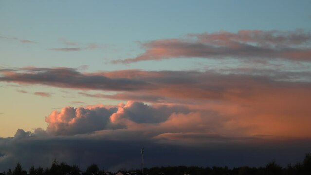 Cloud movement in timelapse over crones trees in the summer evening.
