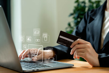 Businesswoman holding credit card and using laptop, Online shopping concept.