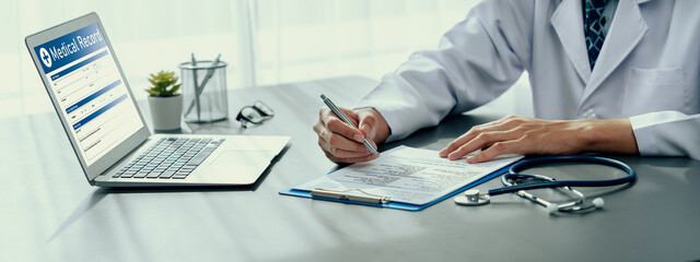 Doctor carefully review detailed medical report on laptop and diagnosing illness for effective...