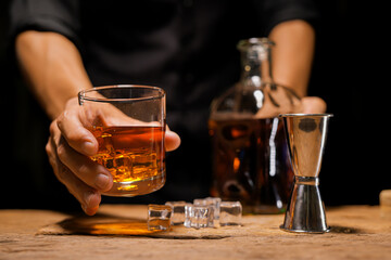 Bartender Serve Whiskey, on wood bar,  - obrazy, fototapety, plakaty