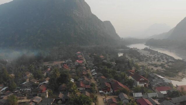 Wide shot of Muang Ngoy village ar Laos during sunrise, aerial