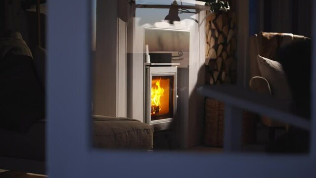 lit fireplace through window view