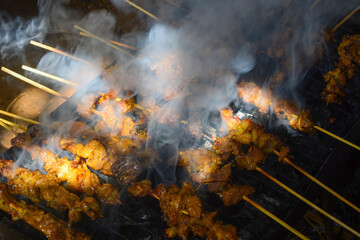 Close up shot of roasted goat satay, a popular dish in Indonesia.