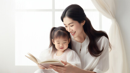 Asian mommy reads bedtime story to her little kid with white background showing love and care to the daughter, Mother and daughter, Parenting - obrazy, fototapety, plakaty