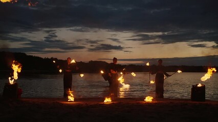 Enigmatic Fire Performance On Beach Of Lake In Night, Light And Darkness