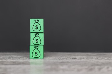 Wooden block with dollar sign. Increased budget, investment fund and profit, capital accumulation concept