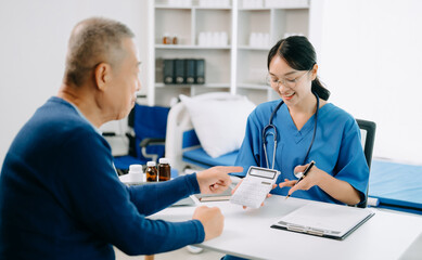 Healthcare costs and fees concept.Hand of smart doctor used a calculator and smartphone, tablet for medical costs at hospital in morning light.