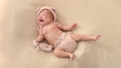 Sleeping newborn cute baby girl or boy during first week of life. 4k slow motion120 fps raw video. Happy family concept. Small baby sleep in bed with small bear toy in hand and nipple