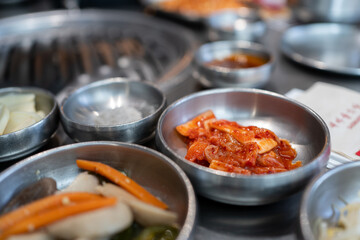 Close up of fresh lettuce cabbage Kimchi or Kimji side dish on stainless steel bowl. Kimchi or Kimji is Korean traditional homemade food in Korea and Asian country. Traditional homemade food concept. - 650558589