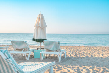 Beach umbrella with chairs loungers on the sand. summer vacation concept
