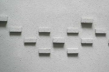 Background decorated with bricks on a rough white wall