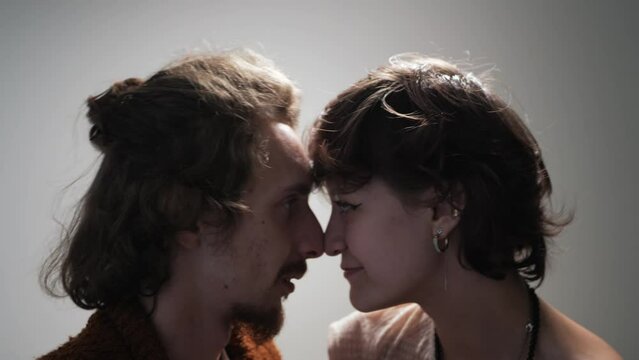 Young couple of lovers rub their noses against each other and smile, romantic evening.