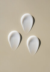 cosmetic smears of creamy texture on a beige background