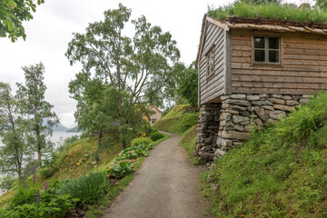 Traditional old wooden house in the mountains. Grass on the roof. Norway