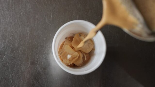 Pouring Coffee Espresso Shot Into Ice Filled Cup Top Shot