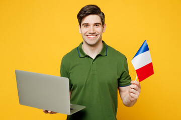 Young caucasian cool happy cheerful IT man wearing green t-shirt casual clothes hold French flag...