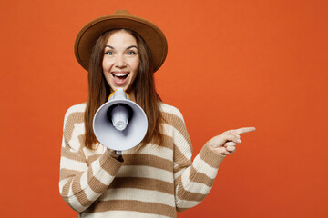 Young woman she wear striped sweater hat casual clothes hold in hand megaphone scream announces...
