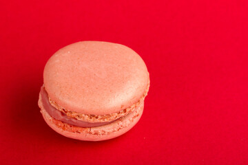 Close up macro shot of a macaron, french snack, on a colourful background.
