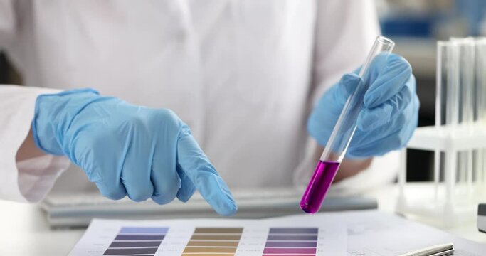 Woman chemist checking acidity of liquid and recording data 4k movie. Innovation in pharmaceutical industry concept