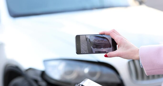 Woman taking pictures of damage on car after accident on mobile phone 4k movie. Car insurance concept