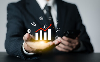 Businessman analyzes financial growth charts, plans marketing strategies and keeps statistics on increasing income. business management concept.