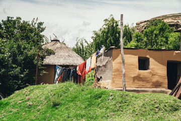 A washing line and traditional huts built with natural materials in a small African village in the alpine country of Lesotho.