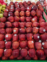 a pile of red apples arranged neatly from far angle