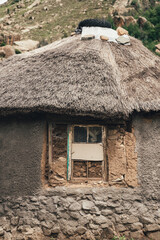 A traditional hut built with natural materials in a small African village in the alpine country of Lesotho.