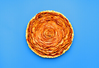 Homemade apple pie top view, isolated on a blue background