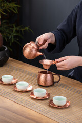 Copper teapot, Chinese tea culture, tea drinking container, teacup and wooden table, carved patterns
