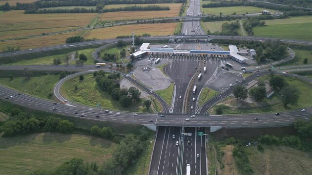 Aerial view of an Italian highway toll booth. Time-lapse cars queuing up to pay the highway toll and automatic paying lanes.