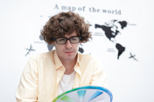 young caucasian man creative graphic designer selecting color swatch samples idea at modern office. Creative startup corporate color product branding design.