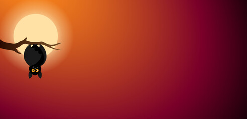 A bat hanging upside down from a tree branch on a moonlit night