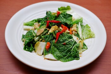 Stir fry Chinese cabbage, stir fry Napa cabbage, tumis sawi putih  served on white plate on...