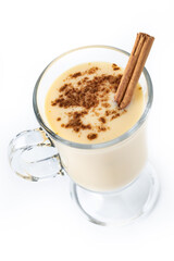 Homemade eggnog with cinnamon on wooden table. Typical Christmas dessert