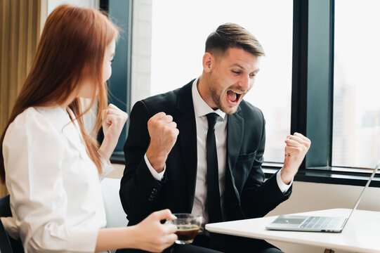 Happy business man looking at laptop screen, celebrating business success,happiness after a successful investment.