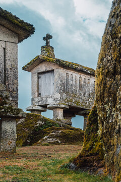 Espigueiros (H&oacute;rreos). Typical stone corn dryers (racecards or granaries lifted to be protected against rodents) crowned with crosses on the stone hill in Soajo. Peneda-Geres park. Minho, Portugal