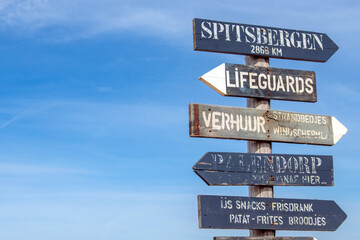 Fototapeta premium Direction indicators against the beautiful blue sky and chapel