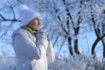 Old woman in a fur coat in the winter 