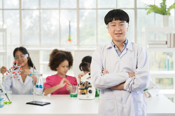 Asian child boy scientists learning science and doing analysis in the laboratory. Science and...