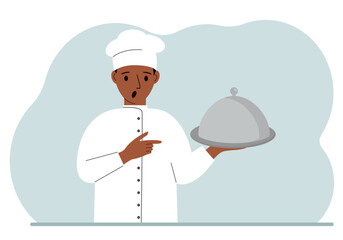 A male chef with a plate covered with a cloche or a tray with a lid.