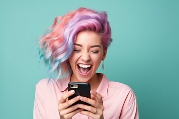 Fototapeta premium Happy young woman with colored hair fall outfit and a smartphone in her hands laughs with jo