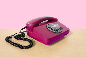 Old pink Rotary Telephone with Disc Dial, Well-Maintained Antiques, calls helpline, Obsolete Technology, Retro Aesthetic 80s