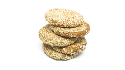 Pile of sesame caramel biscuits or cakes isolated on a white background