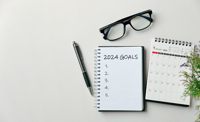 2024 New Year goal, plan, and action concepts. 2024 goals Text on Note Pad with calendar, glasses...