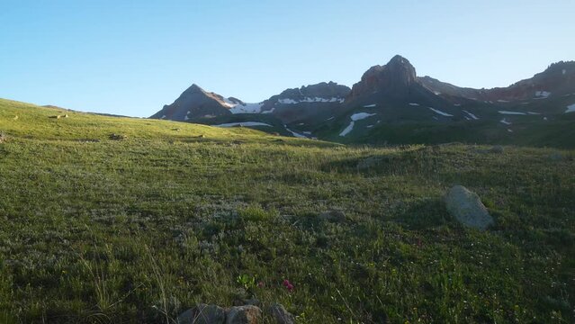 Cinematic Colorado sunset Golden hour Ice Lake Basin Silverton Rocky Mountain high alpine summer snow melted peaks wildflowers stunning view near Telluride Ouray shadows sunset slider to the left