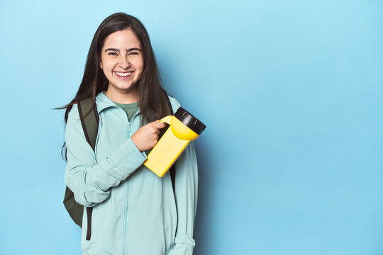 Young woman prepared for night adventure with a backpack and flashlight