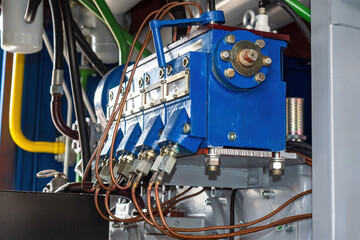 Fuel equipment. Diesel unit. Fragment industrial equipment. Diesel engine. Fuel equipment with thin copper tubes. Petrol pump close-up. Fuel technologies for factory. Aggregate for production machine