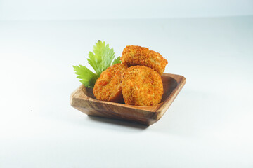 Circle chicken nuggets in a wooden container on a white background. Nugget Lingkaran